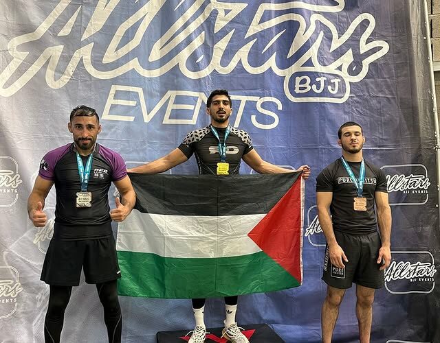 Atom Athlete Belal standing on the podium at All Stars BJJ competition.