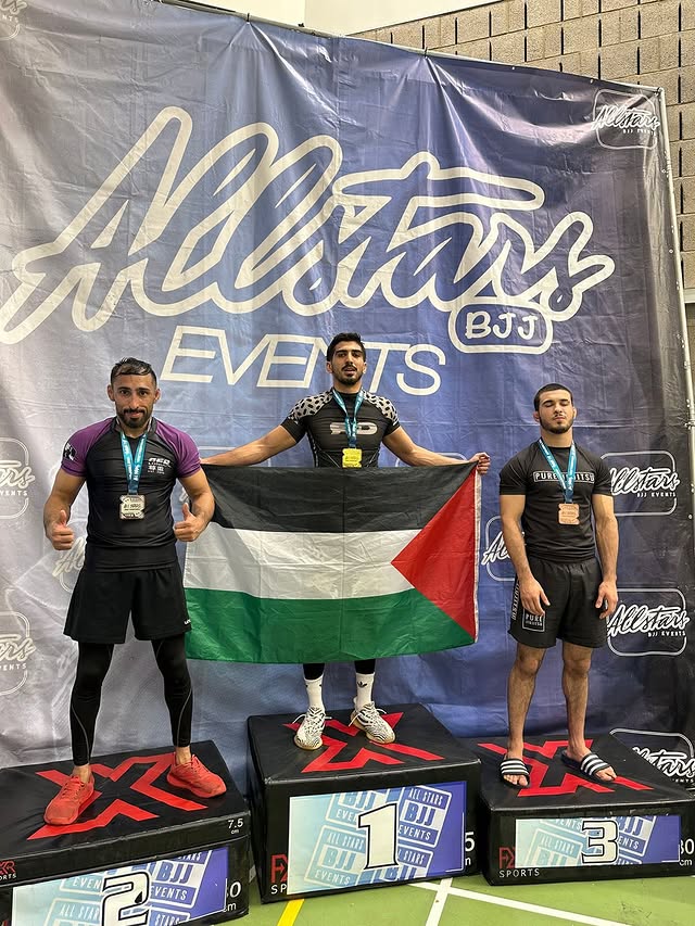 Atom Athlete Belal standing on the podium at All Stars BJJ competition.